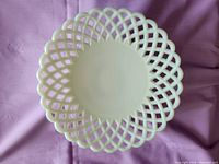 Top view of white milk glass bowl showing the lattice work around the rim and smooth interior base.