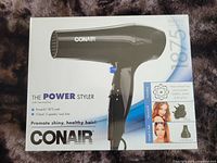 Box front showing Conair 1875 watt hair dryer and product details in English.