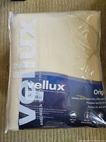 Photo showing the Vellux blanket folded in packaging with large logo and branding visible.