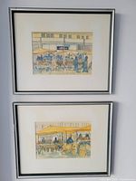 Both framed watercolour and ink drawings of Byward Market hung on a gray wall.