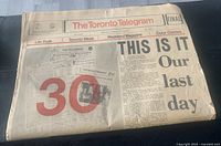 Front page of the final edition newspaper with headline 'THIS IS IT Our last day' and red masthead showing date and issue information.