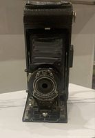 Front view of folded bellows, lens, and shutter mechanism of the Kodak No. 1A Pocket Kodak folding camera.