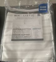 Queen size flat sheet in packaging showing product label with Wholistic branding, Supima cotton, and 400 thread count details.