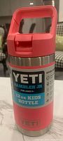 Front view of the pink YETI Rambler Jr 12 oz kids bottle showing the label and brand naming.