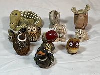 Overview of all 10 multicolored clay animal figurines arranged on a white background