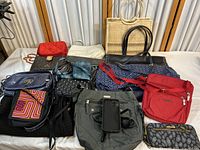 Top view of assorted bags and purses laid out including quilts, patterns, and various materials and colors.