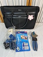 Overall photo of black carrying case with Quickutz hand tool, die molds, Katie Pocket Dies package, and dimensional banner elements in packaging displayed on table