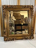 Full front view of the rectangular gold gilt wall mirror showing overall design and condition.