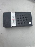 Front view showing tunable AM frequency scale and speaker grille with RCA logo.