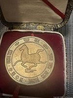 Front of the China tourism coin showing a galloping horse design, surrounded by text in Chinese and English.