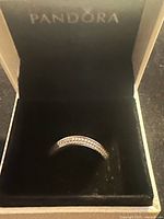 Silver Pandora ring displayed in Pandora black velvet box with logo.