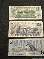 Front and back views of Canadian $1, $10, and $5 bills showing design elements such as parliament buildings, refinery scene, Belted Kingfisher, and portraits.
