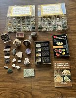 Two plastic cases with many small mineral samples, various loose specimens, and two books
