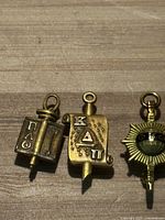 Front view of all three pins on wooden surface.