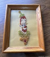 Full view of the framed crystal clown artwork showing the entire piece and the wooden frame