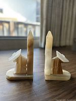 Pair of vintage-style onyx marble bookends with pointed, obelisk-esque vertical sections.