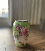 Front view of vintage Royal Rudolstadt porcelain vase showing hand-painted floral design on a green background