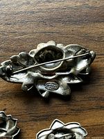 Back side of the water lily brooch showing the pin mechanism and a stamp 'STERLING MEXICO'.