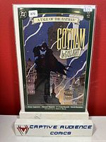 Front cover of Gotham by Gaslight #1 comic book showing Batman in Victorian-era Gotham with lightning in the background and collectible grading sticker visible indicating VF/NM condition.