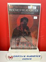 Photo of House of Slaughter #1 comic book with red foil cover, showing front cover, condition label, and protective casing.