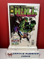 Photo of The Incredible Hulk #454 comic book encased in plastic sleeve with visible NM- condition sticker and Captive Audience Comics stand.