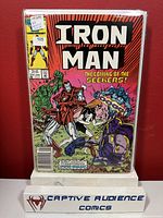 Front cover photo of Iron Man #105 comic book showing dynamic action artwork and seller's grading information.