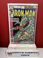 Iron Man #130 comic book front cover in VF condition with clear protective sleeve and Captive Audience Comics display stand.