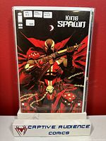 Front cover image of King Spawn #1 comic book variant, displayed in protective sleeve with a stand marked Captive Audience Comics.