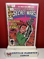 Front cover of Marvel Super Heroes Secret Wars #12 comic book showing character with mechanical arm and title text.