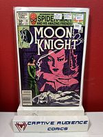 Photo of Moon Knight #14 comic book in protective sleeve with grading and price stickers visible on cover.
