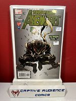Photo of New Avengers #11 comic book cover showing Ronin crouching with sword, held in a clear protective sleeve on a display stand with Captive Audience Comics logo.
