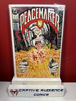 Peacemaker #1 comic book front cover in protective sleeve with price sticker visible showing $125 and condition estimate as NM-