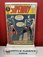 Photo of Superboy #182 comic book with cover art showing Superman, Superboy, Batman, and Robin. The comic is inside a protective plastic sleeve and is rated VG- condition per seller.
