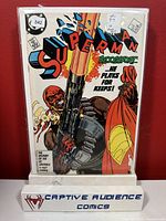 Front cover of Superman #4 comic book showing Blood Sport holding a large gun with Superman.