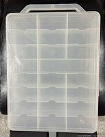 Top view of the transparent plastic carrying case showing 48 individual compartments for diecast cars.
