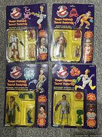 All four sealed figure cards laid out on tabletop