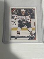Connor McDavid 2018 Topps hockey sticker card in white Edmonton Oilers uniform in protective sleeve.