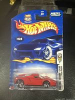 Photo showing full front view of sealed Hot Wheels 2003 First Editions Enzo Ferrari diecast car in original card with blue background and flame Hot Wheels logo, packaged in clear clamshell case.
