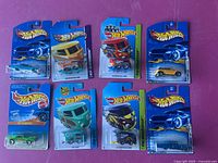 Eight Hot Wheels cars on original packaging cards, older models.