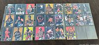 Photo showing 27 individual Crazy Planet wrestling stickers/cards from 1999 featuring various wrestlers in different poses and colors arranged in a sleeve.