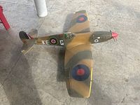 Top-down view of the RC Spitfire model showing wing markings and camouflage paint.