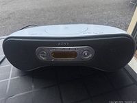 Front view of the Sony portable boombox showing speakers and central control panel with LCD display
