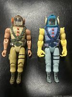 Both vintage Toy Island Video Command Battle Leader figures side by side on black surface.