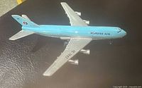 Top view of the vintage Korean Air Boeing 747 diecast toy jet showing the left wing, engines, and fuselage with 'Korean Air' branding.