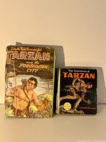 Front view of two Edgar Rice Burroughs Tarzan books, one larger and one smaller showing cover art and titles.