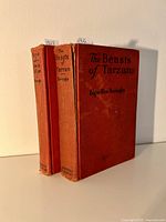 Front view of two red hardcover books titled "The Beasts of Tarzan" and "Tarzan and the Jewels of Opar" by Edgar Rice Burroughs.