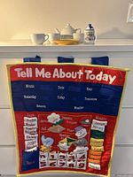 Fabric educational calendar wall hanging with words and fabric tabs for days, months, weather, seasons, and date tracking