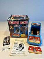 Overview of console, box, manuals, promotional insert and spare faceplate