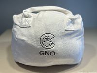Soft fabric carrying bag for weighted blanket with embroidered GNO logo shown from front.