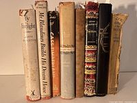Front view of the set of eight vintage hardcover books showing titles and condition.